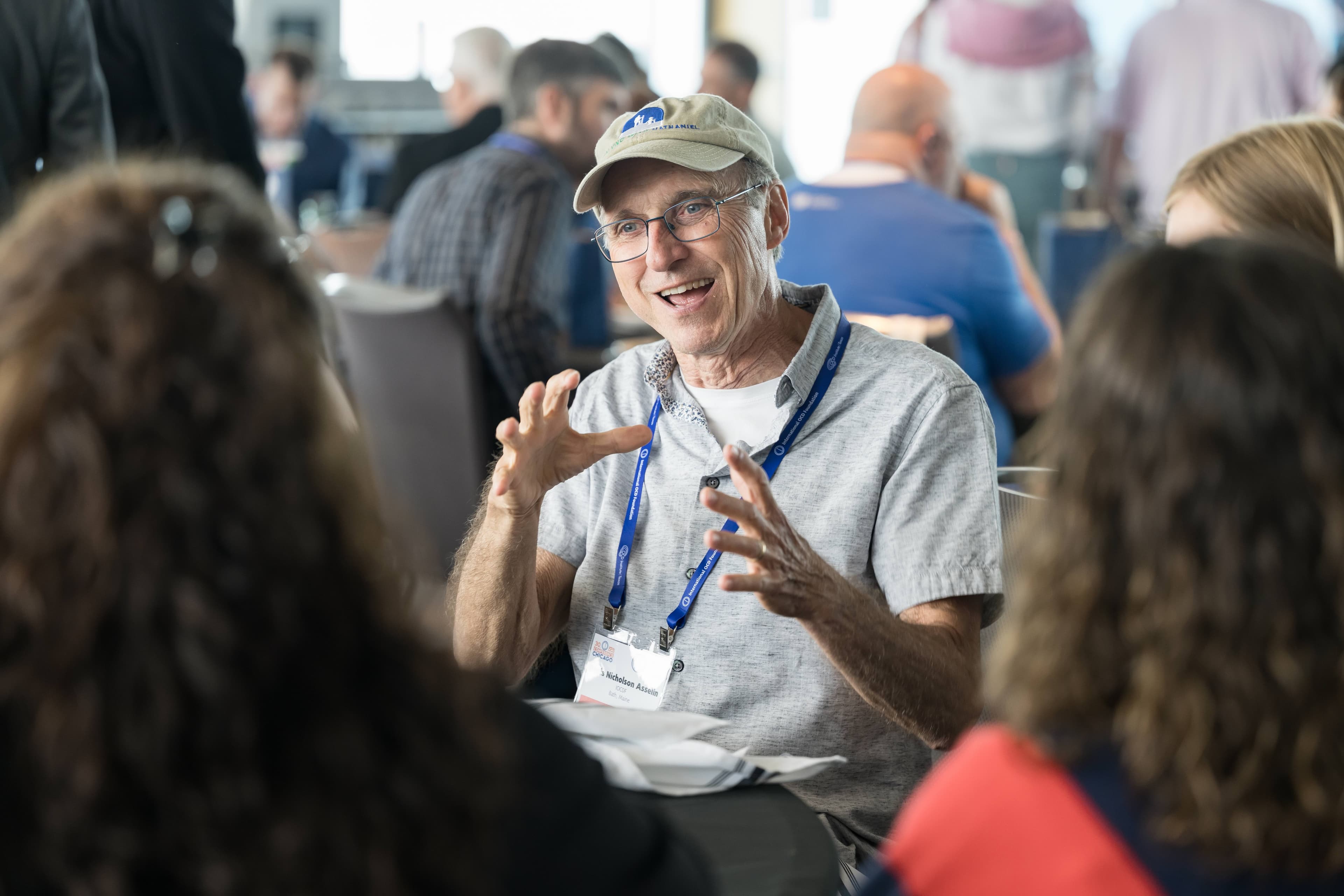 Smiling woman giving a piggyback ride to a laughing young girl.